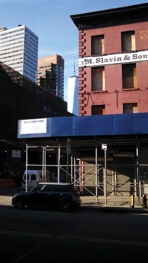 Downtown Express photo by Josh Rogers The Slavin and Sons building in the South Street Seaport Historic District is still boarded up with an “X,” after Hurricane Sandy damage more than two years ago. 