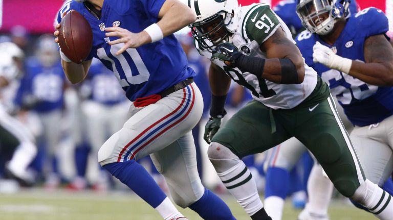 Calvin Pace #97 of the New York Jets puts pressure on Eli Manning #10 of the New York Giants at MetLife Stadium on Sunday, Dec. 6, 2015 in East Rutherford, N.J.