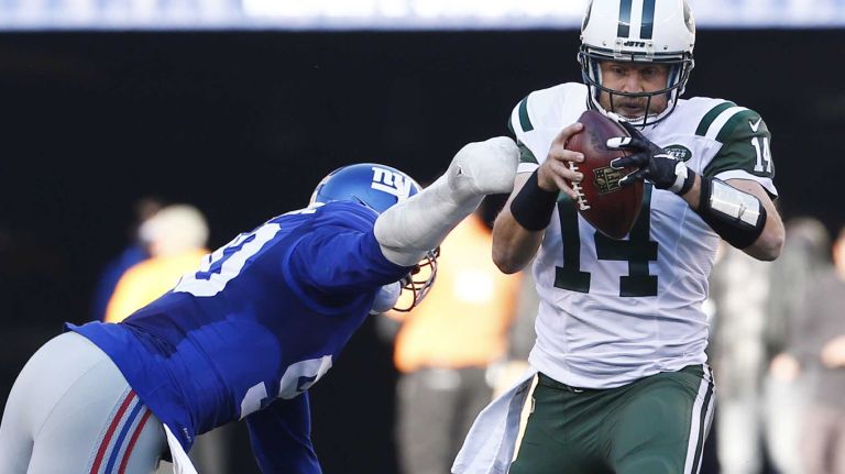 Ryan Fitzpatrick #14 of the New York Jets avoids a sack from Jason Pierre-Paul #90 of the New York Giants at MetLife Stadium on Sunday, Dec. 6, 2015 in East Rutherford, N.J.