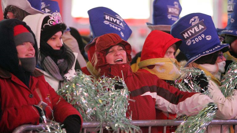 Times Square New Year's Eve celebrations through the years 12 People dance as they wait for the traditional New Year's Eve ball drop in Times Square on Dec. 31, 2008.