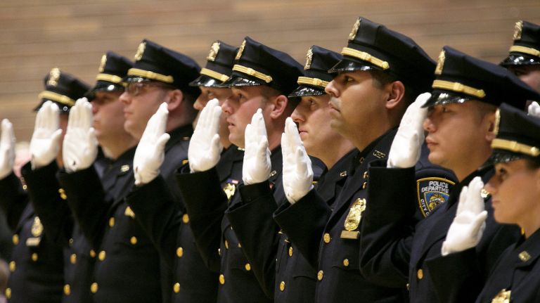NYPD promotes about 300 officers and civilians 2 Members of the NYPD take the oath at a promotion ceremony at One Police Plaza in Manhattan on Thursday, Dec. 17, 2015.