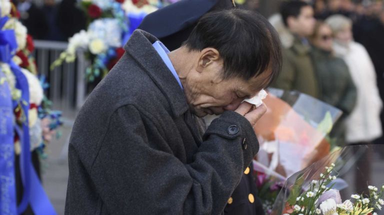 Wei Tang Liu attends a prayer vigil and wreath-laying ceremony honoring his son Detective WenJian Liu and Detective Rafael Ramos and on Tompkins Avenue in Brooklyn on Sunday, Dec. 20, 2015. Liu and Ramos were shot and while in a squad car on Tompkins Avenue last December.