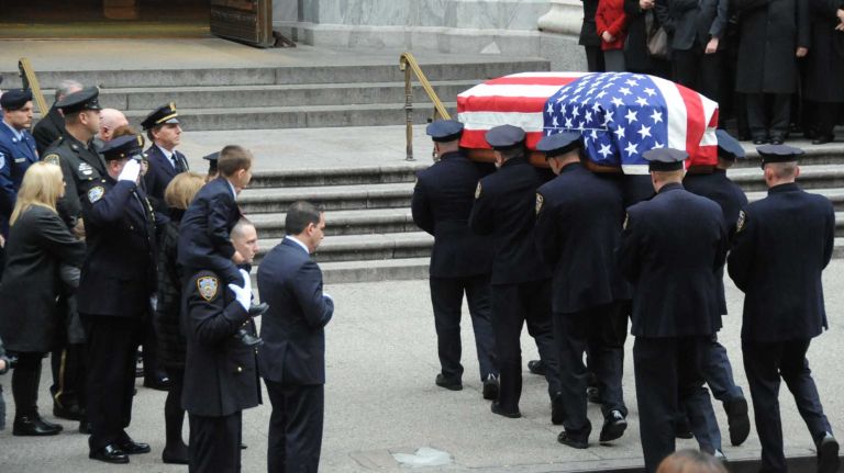 New York City Police Department officers carry the coffin of NYPD detective and Air National Guardsman Joseph Lemm into St. Patrick's Cathedral on Dec. 30, 2015 for his funeral Mass. Lemm was one of six American service members who died in a Dec. 21 attack.
