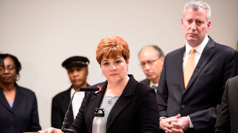 A pragmatist and a progressive -- again 2 New York City Mayor Bill de Blasio, right, and others listen as Christine Quinn, CEO of the Women in Need shelter in the East New York section of Brooklyn, speaks during a news conference on Wednesday, Dec. 23, 2015.