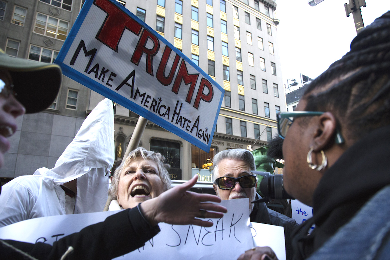 A female counter protester, pro Trump and third one from the left, screams and confronts anti-Donald Trump protesters at Trump Tower in 5th Avenue in New York, as Republican presidential front-runner Donald Trump has been calling for barring all Muslims from entering the United State. Dec 20, 2015, New York.