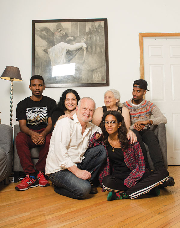 Photo by Monty Stilson Craig Smith and his family, in their E. 5th St. home, from left, Tesfahun SmithStone, Elise Stone, Craig Smith, Sandy Stone, Hakima SmithStone and Kerem SmithStone.