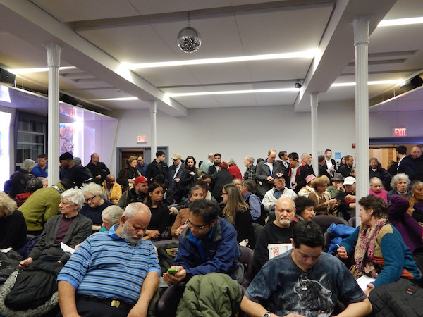 Q&A and Assurances at Crowded Town Hall 1 Residents settled into seats, as preparations for the Town Hall meeting began. Photo by Lindsay Bu.