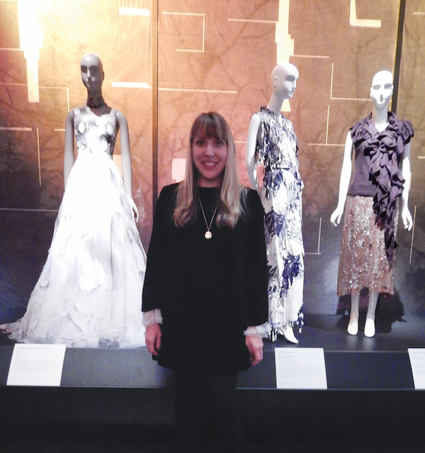 Once upon a time, told with style 3 Colleen Hill, associate curator of costume, standing in front of the “Cinderella” installation, one of her favorites from the exhibit. Photo by Lindsay Bu.