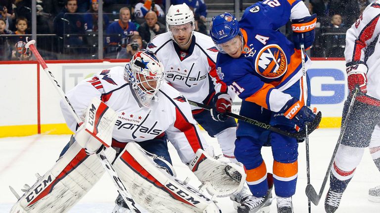 Braden Holtby and Taylor Chorney of the Washington Capitals defend against Kyle Okposo of the New York Islanders during the first period at Barclays Center on Thursday, Jan. 7, 2016.