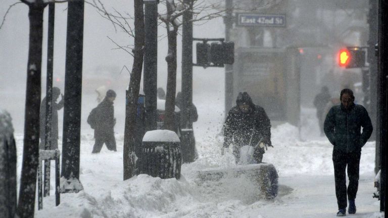 People are seen trudging along in snow along 3rd Avenue in Manhattan on Saturday, Jan. 23, 2016. A snow emergency is currently in effect as accumulations in the city could top out at over a foot before the storm is expected to end this evening.