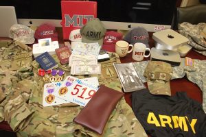 Police found military uniforms and decorations, Harvard and MIT hats, cash and foreign passports at the Hanover Square home of a man accused of posing as a war veteran to lease a BMW. 