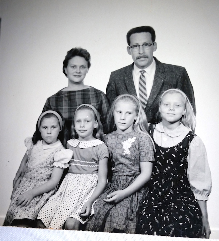 Front row, from left, Lenore, 7, Diane, 8, Jenean, 9, and Dorothy, 10, with Romola and David Lloyd Wilkie — later known as Adam Purple — on their passport photo to emigrate to Australia in 1964. 