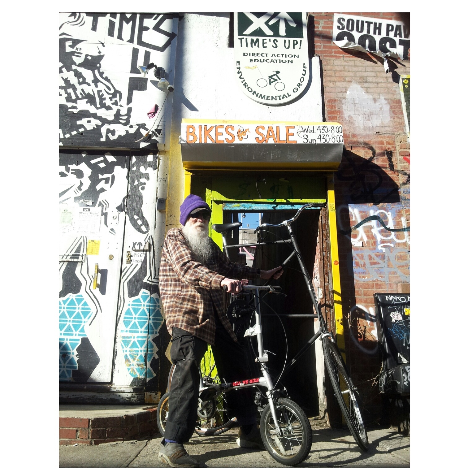 Adam Purple a.k.a. David Lloyd Wilkie on his folding bike outside the Time’s Up headquarters in Williamsburg, Brooklyn. For his last couple of years, Wilkie lived in a small room at the environmental and cycling group’s space. He died in September of heart failure while biking on the Williamsburg Bridge, possibly returning from grocery shopping in the East Village.