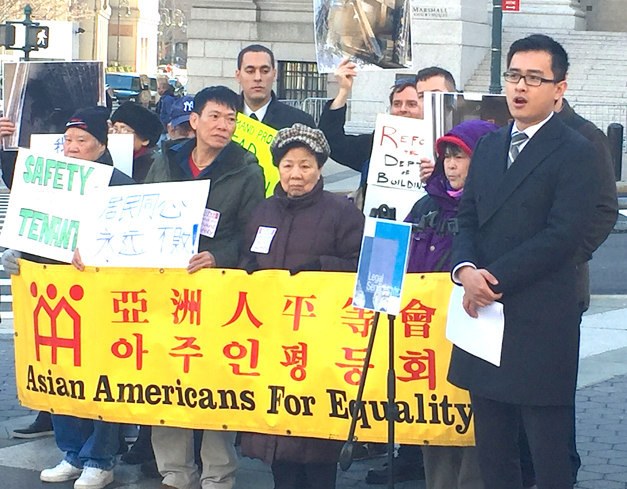 William Xu, right, of Asian Americans for Equality introduced the speakers at Foley Square Monday and gave a general overview of what he called the illegal and dangerous actions taken by King Henry Realty. “The landlord has continued to conduct construction without permits in the building as a form of harassment," Wu charged. "He has also failed to upkeep the building, and has allowed it to deteriorate into a state of disrepair, with substandard living conditions that pose a health and safety risk to our tenants."  Photo by Joaquin Cotler 