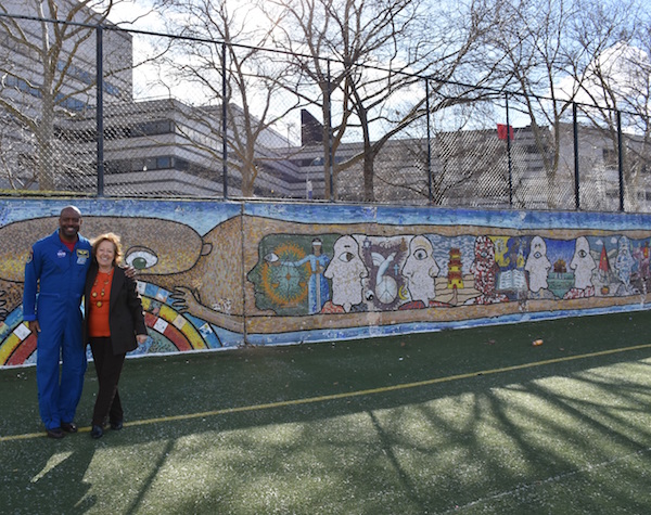 CITYarts Seeks Support for Chelsea Mural Projects 1 Tsipi Ben-Haim, in front of the newly restored Harlem Peace Wall on W. 138th St., with astronaut Leland Melvin, who recently spoke to middle and high schoolers at a CITYarts sponsored event. Photo courtesy CITYarts.