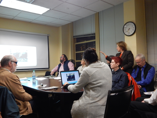 CITYarts Seeks Support for Chelsea Mural Projects 2 At a Feb. 11 CB4 meeting, CITYarts representative Tsipi Ben-Haim (under clock) gave a presentation on murals her organization plans for two local parks. Photo by Sean Egan.