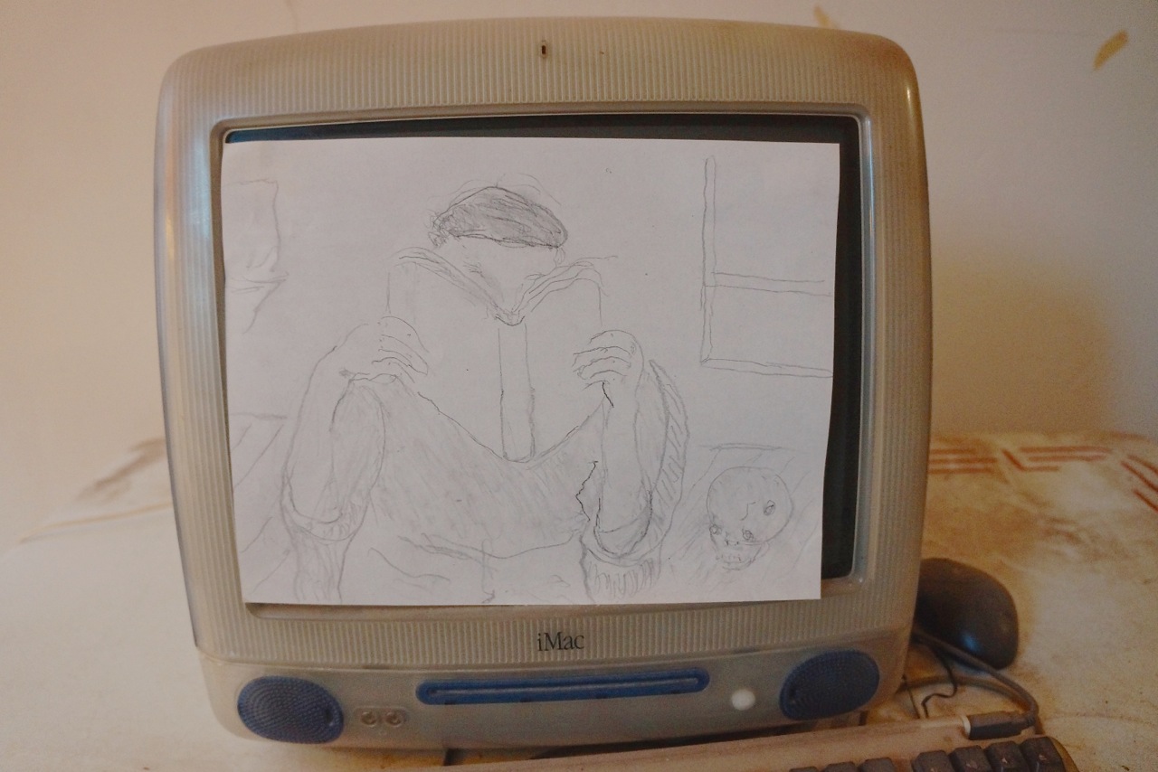 A drawing of a reader covered the screen of a Mac computer in his room.  Photo by Sarah Ferguson 