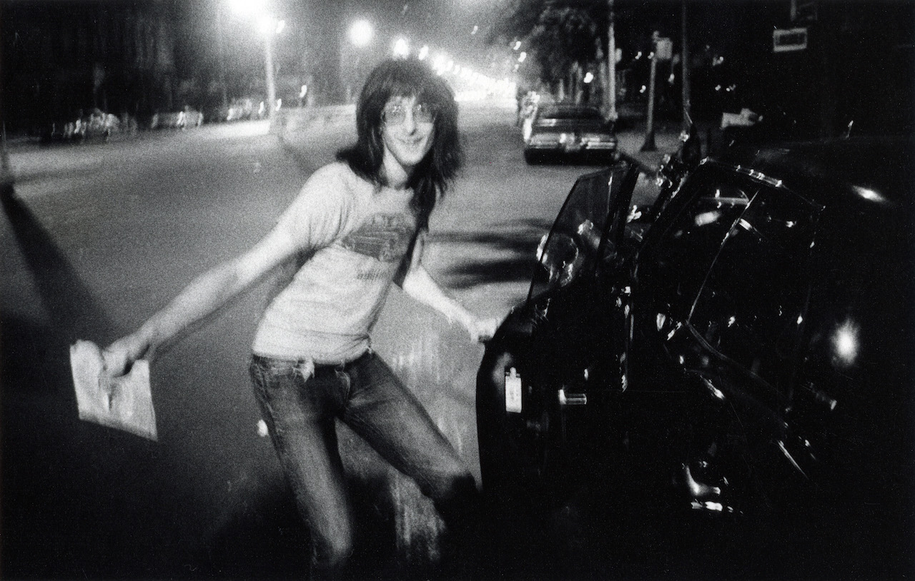 Lenny Kaye getting into his 1968 Chevy outside of CBGB in 1977.