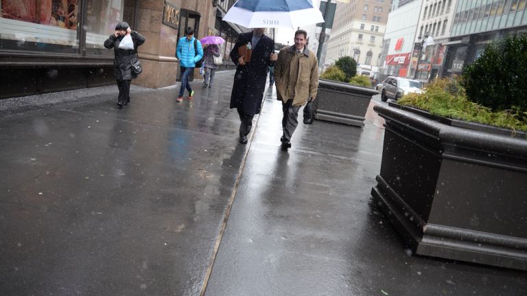 NYC weather: Light snow coats Manhattan 9 Keep an eye on your surroundings when navigating under the luxury of an umbrella on a snowy Monday, Feb. 8, 2016, in Manhattan.
