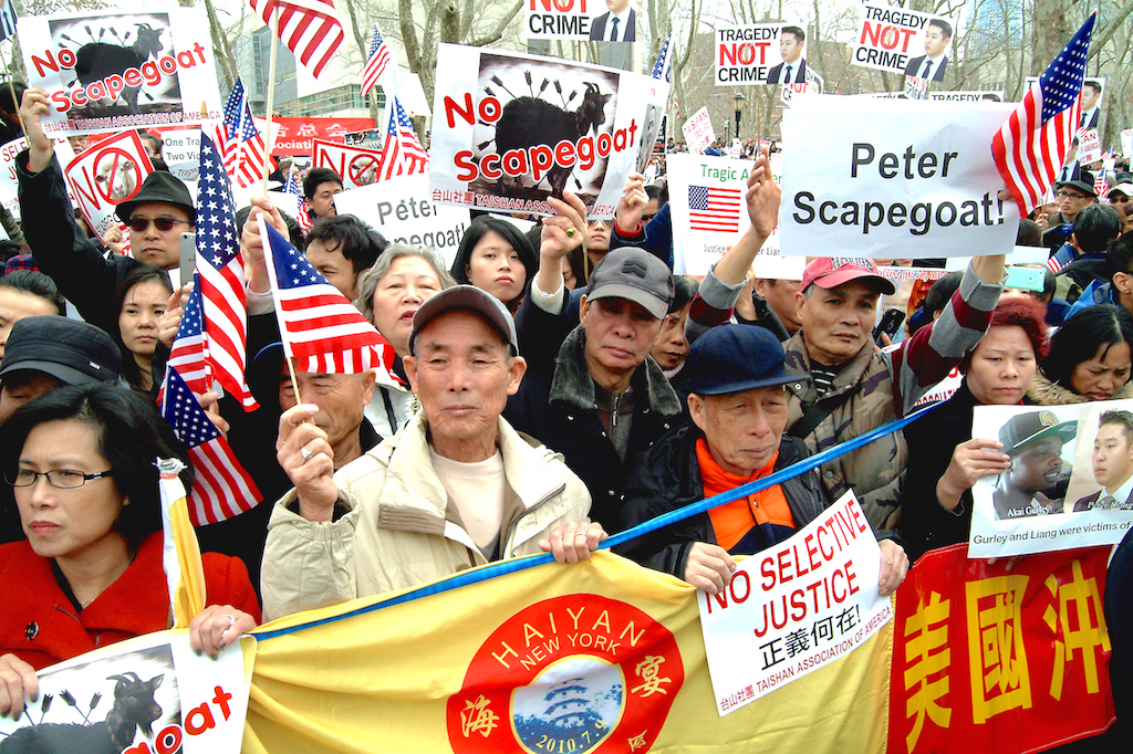 A Protest at Brooklyn Bridge Park in support of former NYPD officer Peter Liang who faces a 15 year jail for the accidental shooting of Akai Gurley inside the Pink Houses was attended by more that 10,000 people mostly Asian carrying signs and chanting No Justice No Peace