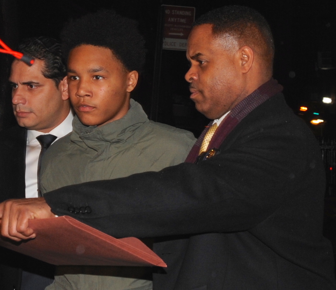 Detectives from the 6th. precinct , on West 10th street, remove the slashing suspect, Dominico Howington 16,  to a waiting vehicle for transportation to Manhattan Criminal Court's Central Booking.  (Sam Costanza for New York Daily News)