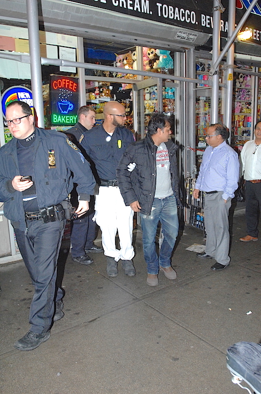 Police secured the "SWEETS SHOP" located at 203 Spring Street where a strong arm robbery of the store, and an assault on an employee, occurred at approximately 6:30pm this evening. The injured employee, pictured here with EMS technician, was removed to a local hospital in non life-threatening condition.  (Sam Costanza for New York Daily News)