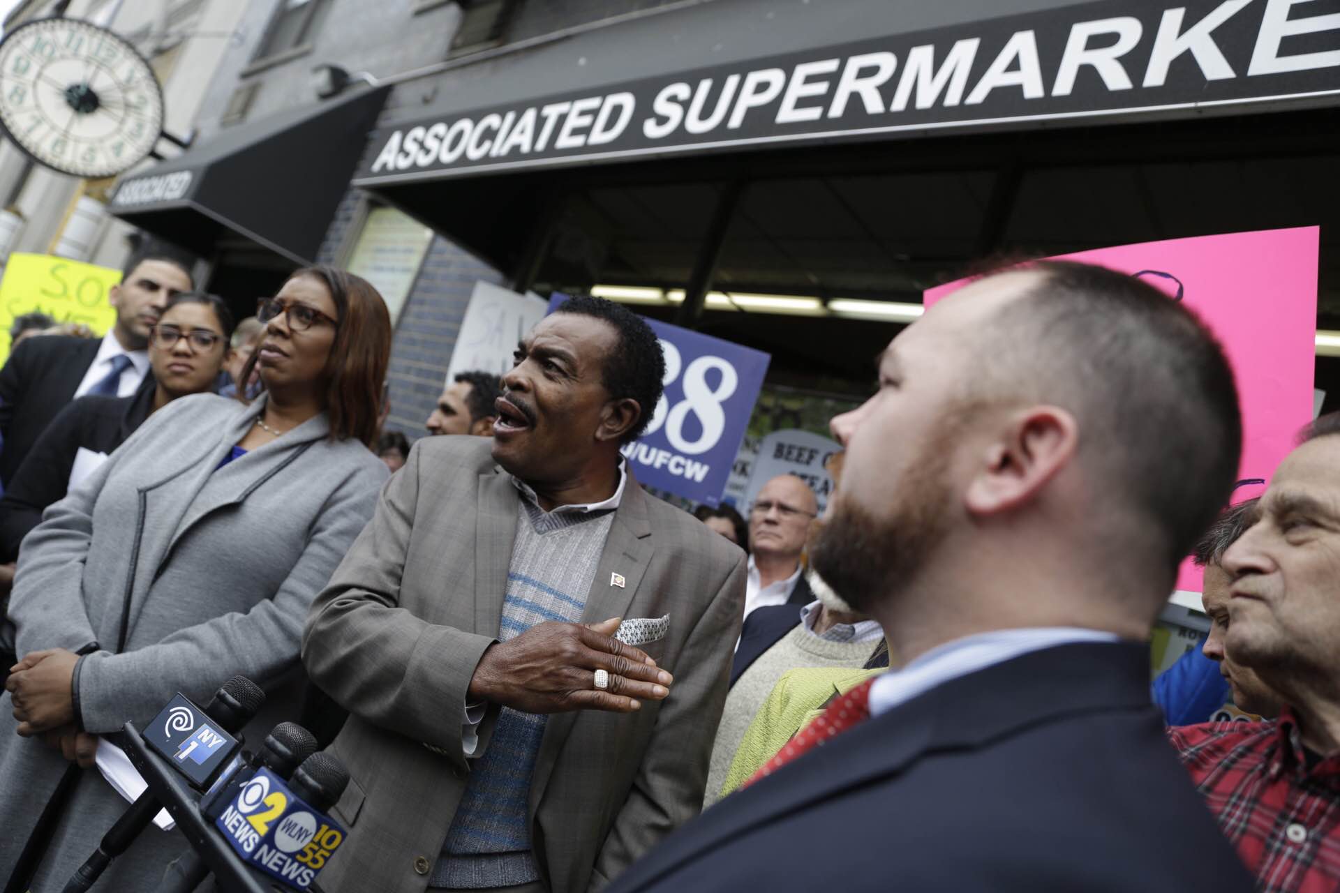 Fighting to keep budget food market from having to check out on 14th St. 1 Gladwin Francis, an owner of the W. 14th St. Associated supermarket, spoke at Sunday’s rally, as he was flanked by Councilmember Corey Johnson, right, and Tobi Bergman, C.B. 2 chairperson, right background, and Public Advocate Letitia James, left, and Assemblymember Richard Gottfried, obscured from view behind him. Photo by William Alatriste / NYC Council