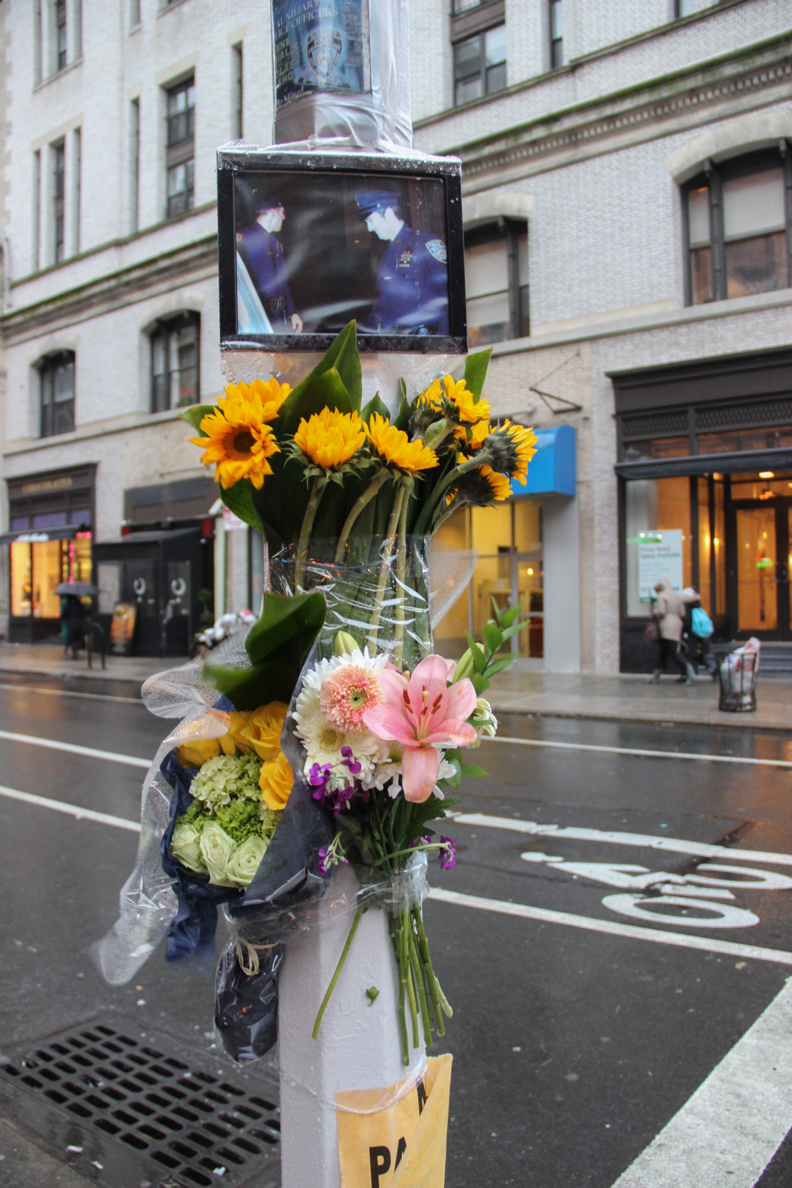 Honoring hero auxiliaries 1 Flowers and a photo of Auxiliaries Nicholas Pekearo and Yevgeniy Marshalik left at Monday’s memorial. Photo by Tequila Minsky