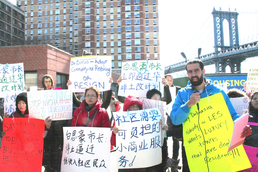 Lewis Barnes, a volunteer with NMASS, right, speaking at Wednesday’s protest at the One Manhattan Square project site, which his group organized.   Photo by Yannic Rack