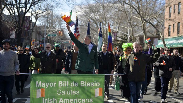 New York City Mayor Bill de Blasio waves to the crowd as he marches Sunday, March 6, 2016, up Skillman Avenue in the St. Pat's for All Parade in Sunnyside and Woodside.