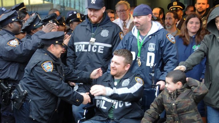 Scott Forster has written an open letter explaining why he left the hospital where NYPD officers William Reddin and Andrew Yurkiw were after being shot on the job in Bed-Stuy. Pictured: Reddin leaves Kings County Hospital in Brooklyn on Feb. 23, 2016; behind him in Yankees cap is his partner, Yurkiw. 