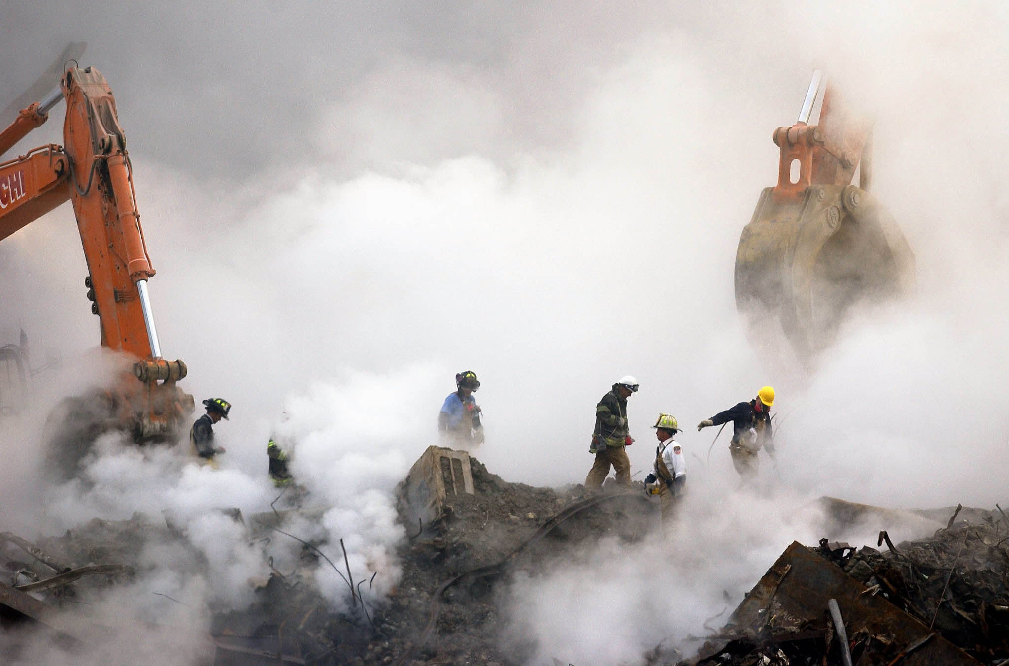 Photo by Associated Press / Stan Honda Even a month after the 9/11 attacks, the still-smoldering wreckage at Ground Zero spewed noxious smoke and toxins into the air.