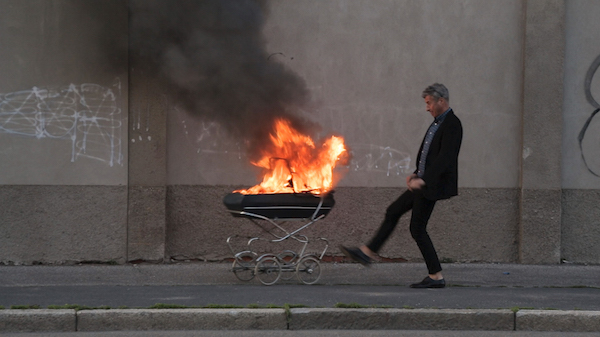 Do the math: Tribeca Film Fest x 15 = 2016 1 Maurizio Cattelan kicks a burning baby carriage in Milan, in “Maurizio Cattelan: Be Right Back.” Photo courtesy Maurizio Cattelan Archive.