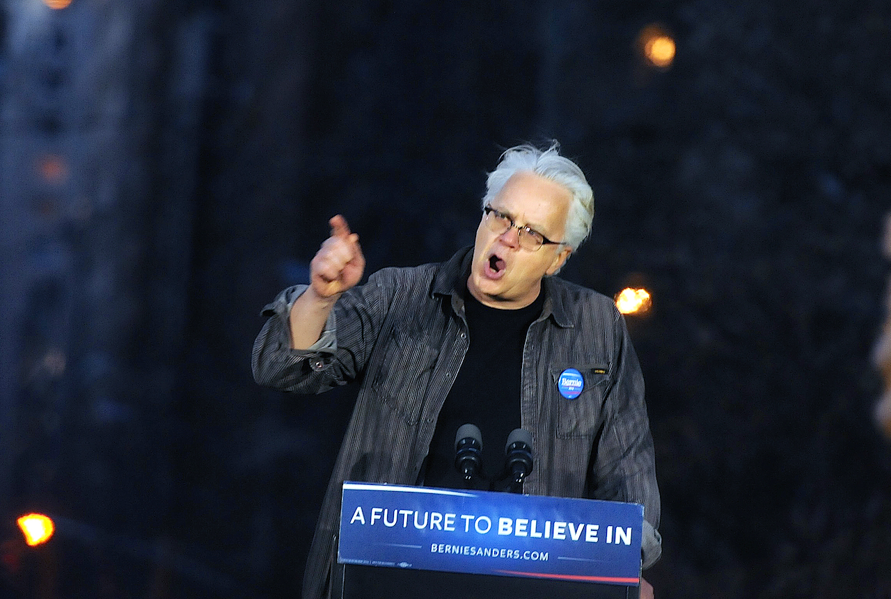 Photo by Jonathan Alpeyrie Actor Tom Robbins urge the crowd not to buy the media-created narrative of Hillary Clinton’s greater “electability,” when polls actually show that Sanders does better than her against the Republican presidential candidates.