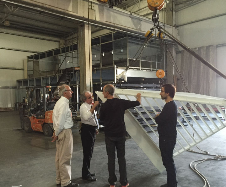 Two members of the Argentinian fabricating company, at left, confer with the memorial’s architects, Esteban Erlich and Mateo Paiva, both of Studio A+I. 