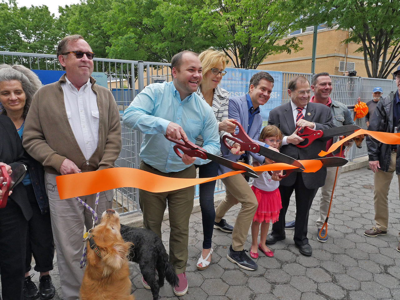 Local politicians, including Councilmember Corey Johnson, second from left, state Senator Brad Hoylman, fourth from left, Congressmember Jerrold Nadler, fifth from left, and Assemblymember Deborah Glick, not shown, joined dog run members and Hudson River Park Trust officials to cut the ribbon on the spruced-up new run.