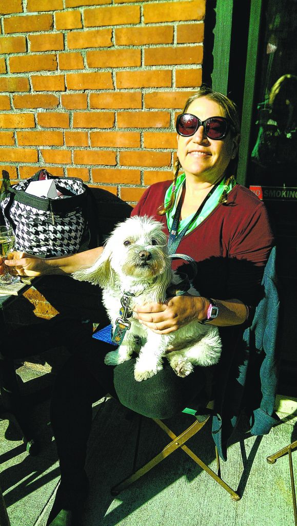 Photo by Janel Bladow Battery Park City resident Leslie Lipton enjoyed the spring weather with her dog down at the Seaport at Acqua on Peck Slip.