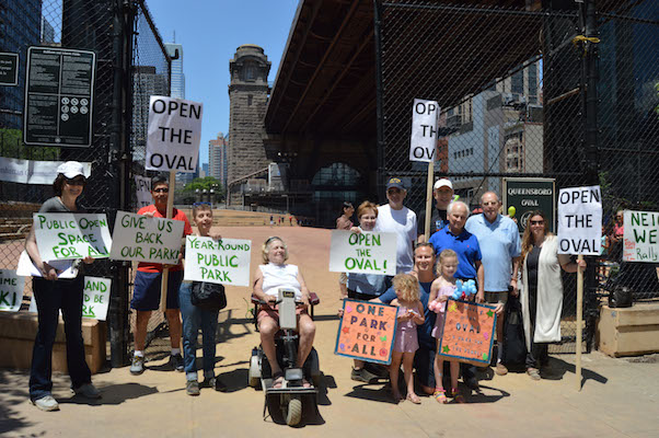 Community residents and CB8 members just outside the entrance to Queensboro Oval at a June 25 rally demanding that the park be opened up to the public. | JACKSON CHEN 