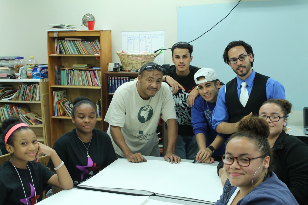 Graffiti artist Antonio Garcia a.k.a. Chico, third from left, and Eric Diaz, director of Vision Urbana, at rear right, working with teenagers in the Legends of L.E.S. Project.  Photo by Michael Ossorguine