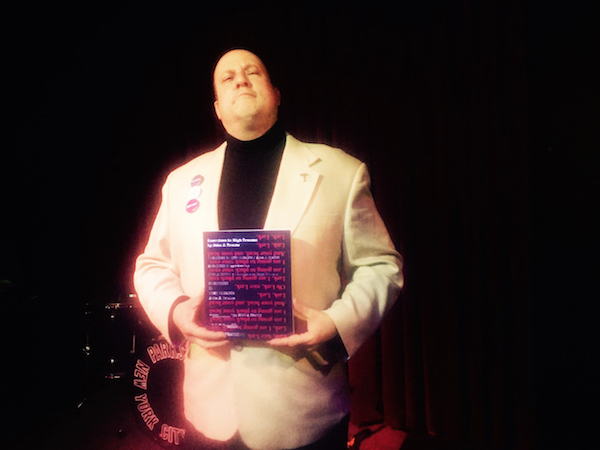 Sappho tribute artist John J. Trause, with his latest book. Photo by Puma Perl.