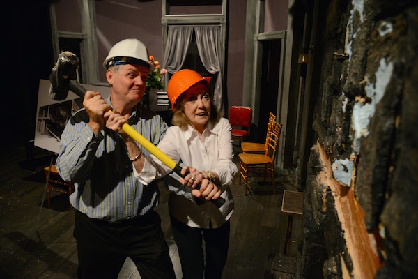 Irish Rep co-founders Charlotte Moore and Ciarán O’Reilly administer a little tough love to the wall of their W. 22nd St. theatre, in 2014. Photo by James Higgins.