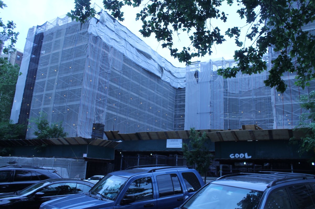 As dusk falls, The Neighborhood School building starts to resemble something out of “Close Encounters of the Third Kind,” as construction lights go on behind the safety netting and the pounding, chipping and drilling sounds commence.