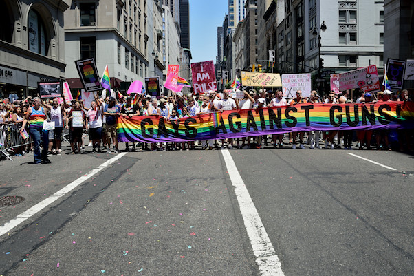Gays Against Guns march behind a banner created by Gilbert Baker, designer of the Rainbow Flag. | DONNA ACETO 