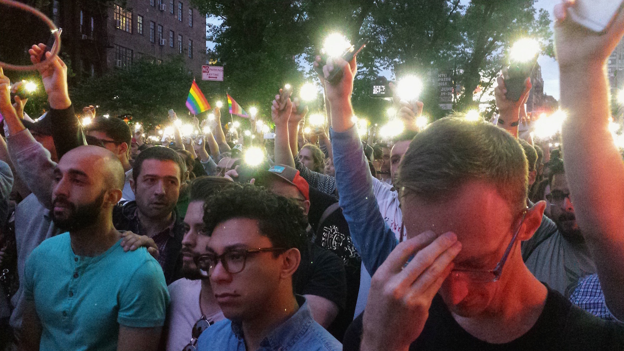 At this past Monday's vigil, during the reading of the names of the 49 dead in the Orlando Pulse club shooting, the crowd on Christopher St. raised their cell-phone flashlights as one and said "presente" (present in Spanish) after each name was read. Photos by Lincoln Anderson