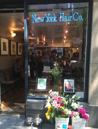 Flowers in memory of Andrew Gould sit side by side with water bowls for passing dogs outside his NY Hair Co. salon. | COURTESY: CHRISTINA WONG 