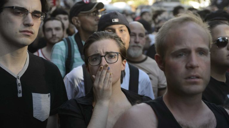 People gather at The Stonewall Inn in Manhattan on Sunday, June 12, 2016, at a vigil for Orlando, Fla., shooting victims. A gunman armed with an assault rifle and handgun killed 49 people and wounded 53 at Pulse, a gay nightclub in Orlando, in what officials termed the worst mass shooting in U.S. history.