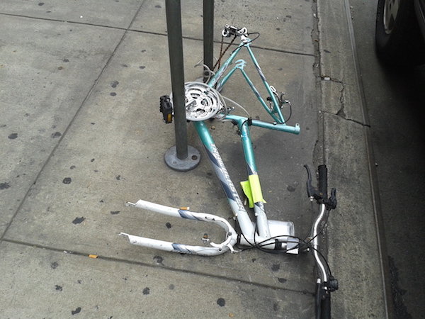 Tagged for removal, this derelict bike on Seventh Ave., btw. W. 21st & W. 22nd Sts., doesn’t seem to meet all of the removal requirements put forth by the DSNY. An Aug. 9 hearing will consider amending their criteria. Photo by Scott Stiffler.