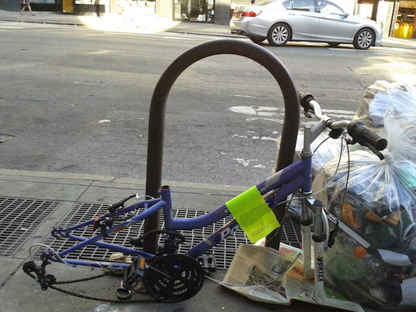 Waiting along with the rest of the trash: a bike on Seventh Ave., btw. W. 23rd & W. 24th Sts. Photo by Scott Stiffler.