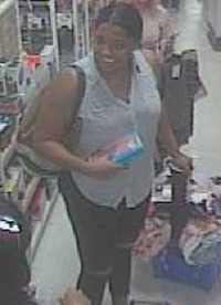 The second suspect, last seen wearing a light blue sleeveless shirt, black Capris, and carrying a black purse. Courtesy DCPI.