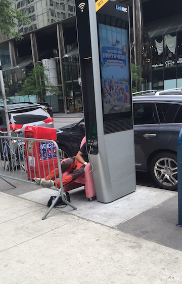 A digital squatter pulls up an easy chair next to a LinkNYC kiosk in a photo taken by a Manhattan resident who wished to remain anonymous.